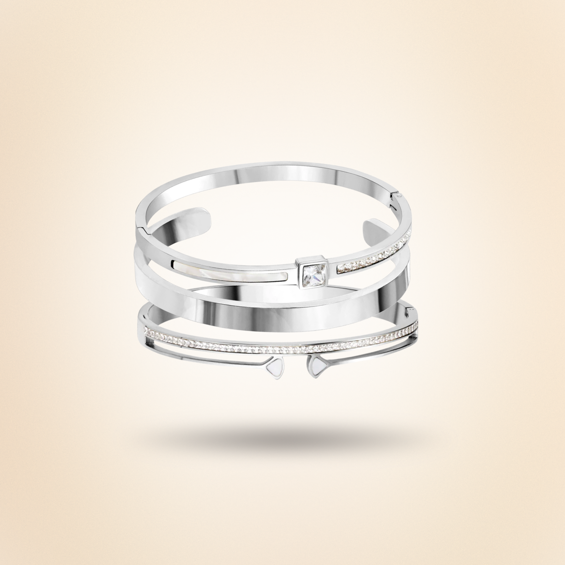 Silver bracelet stack with a diamond on a beige background