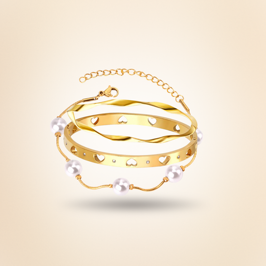 Gold bracelet with pearls on a beige background