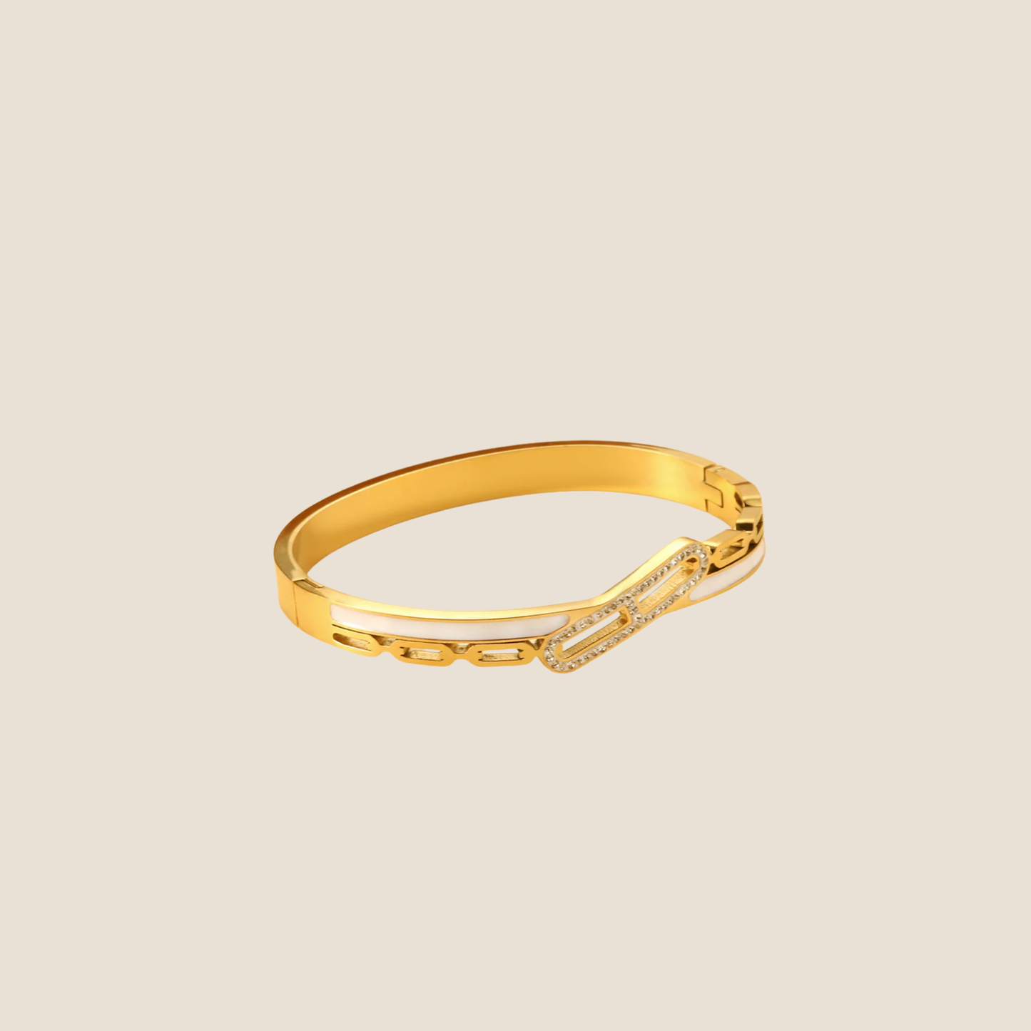 Gold bracelet with small stones on a beige background