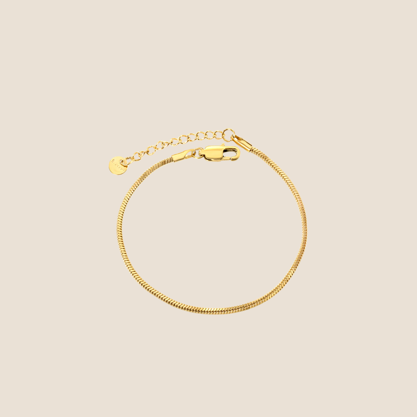Gold bracelet on a beige background