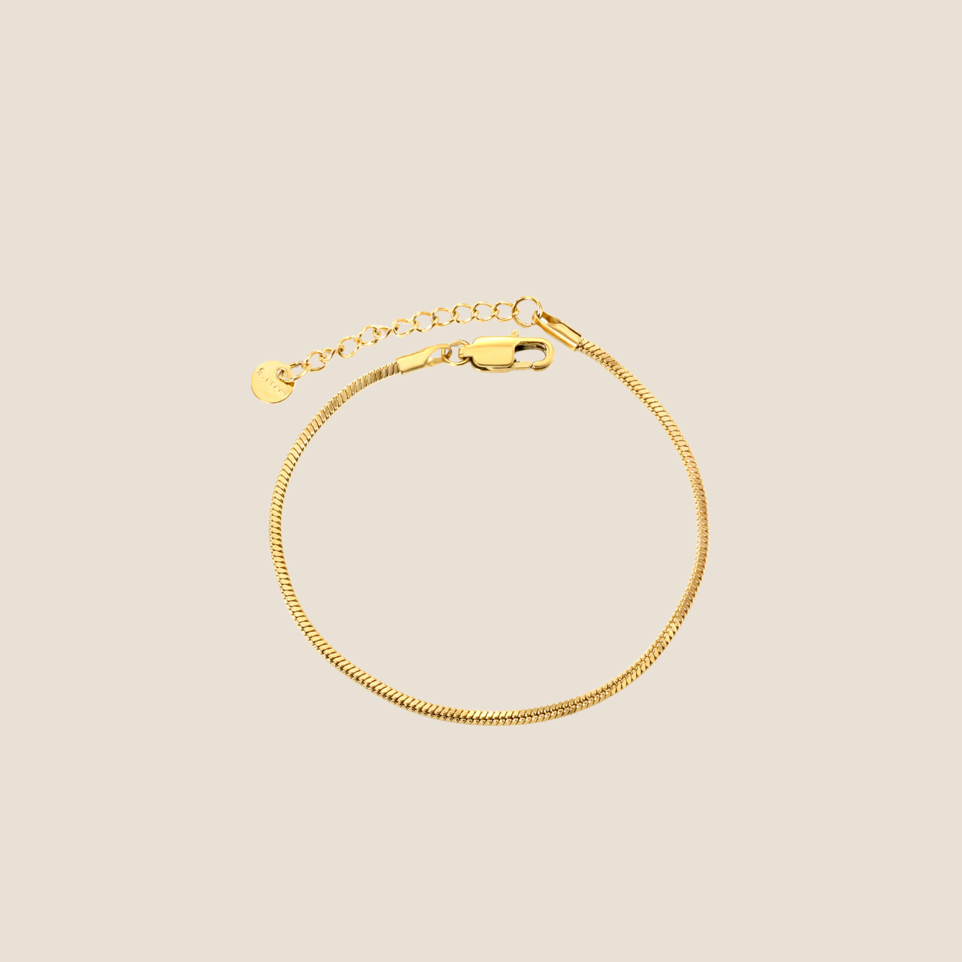 Gold bracelet on a beige background