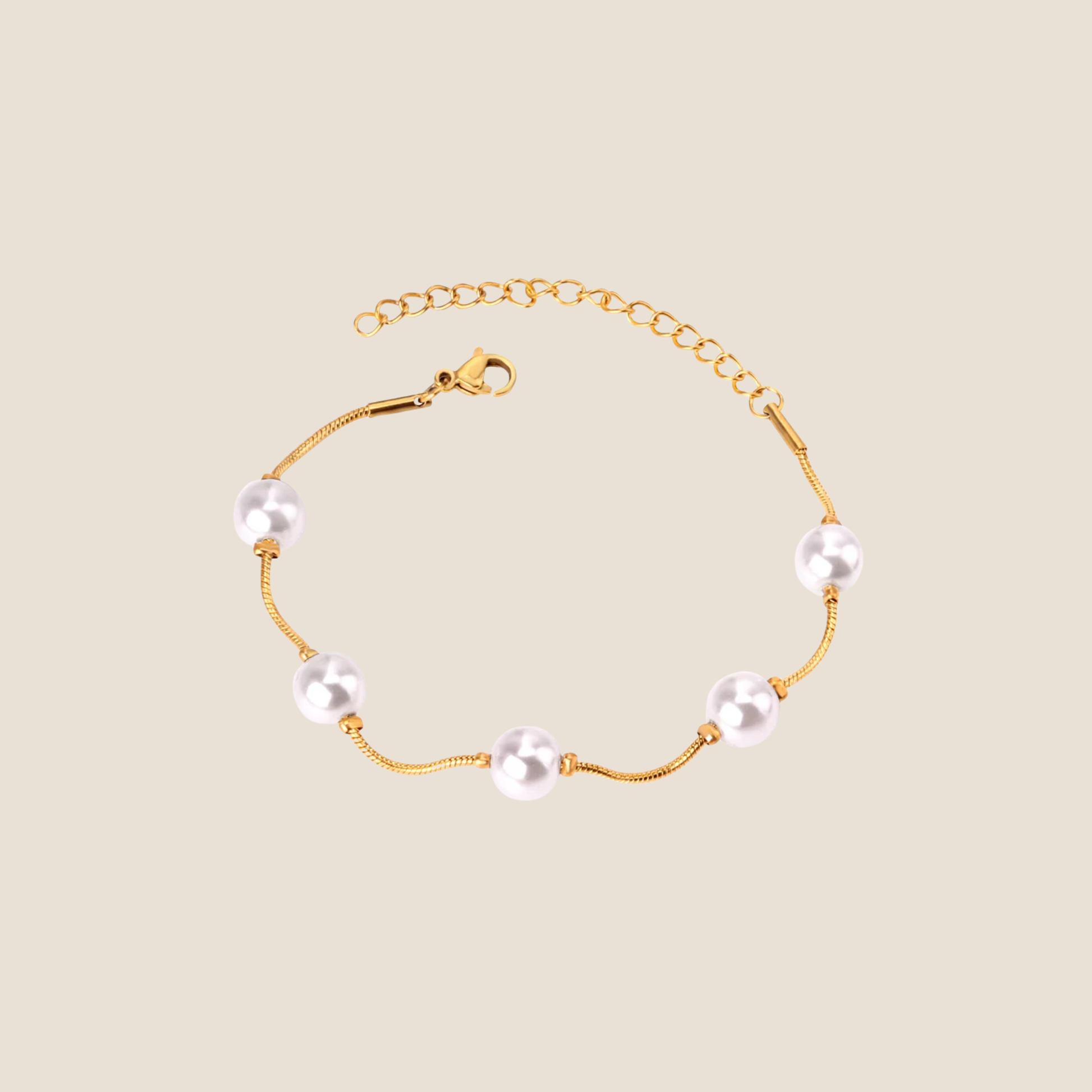 Gold bracelet with pearls on a beige background