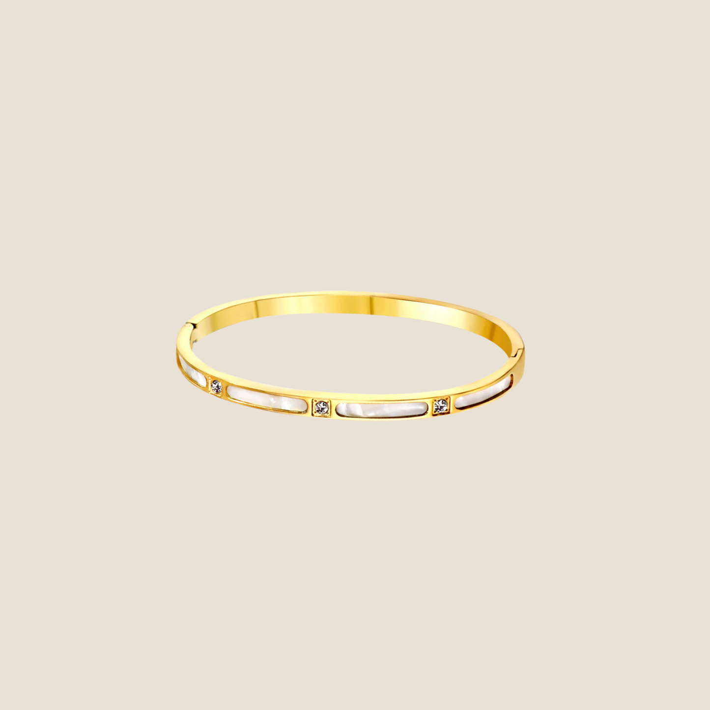 Gold bracelet on a beige background