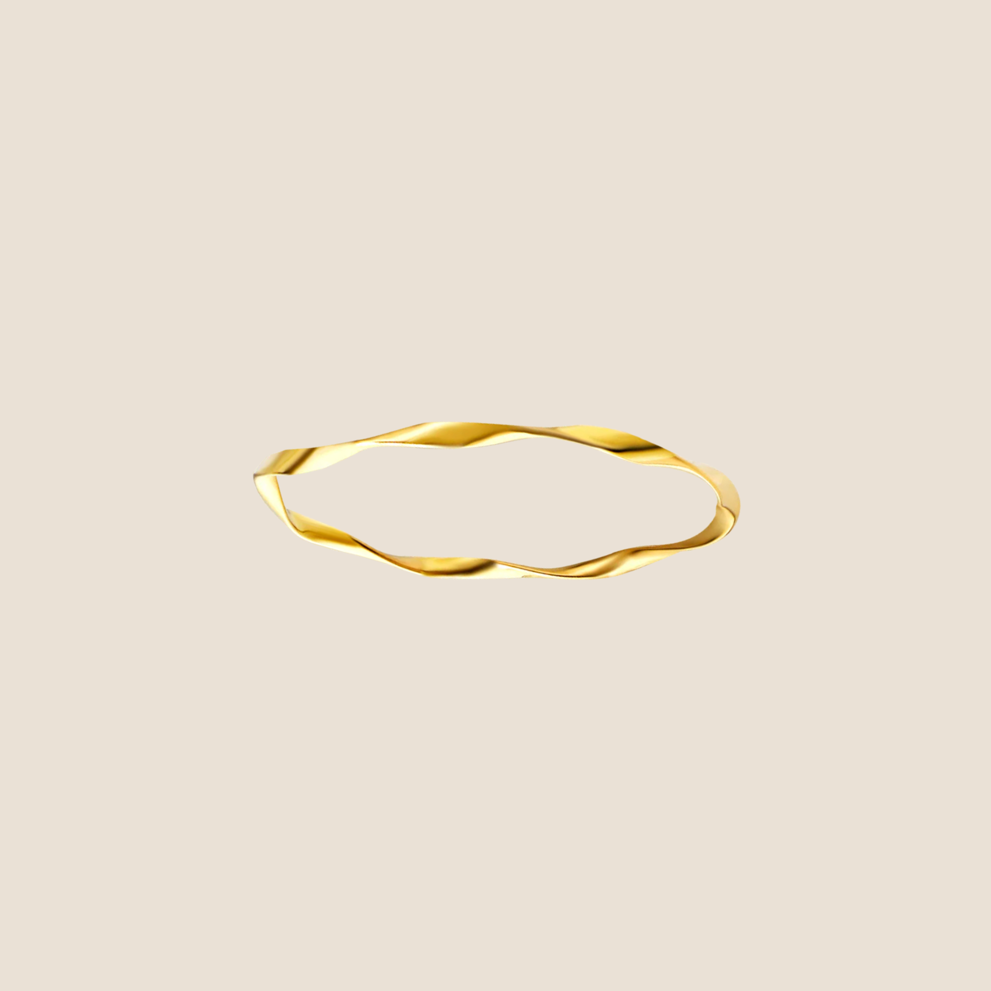 Gold ring with a wavy design on a beige background